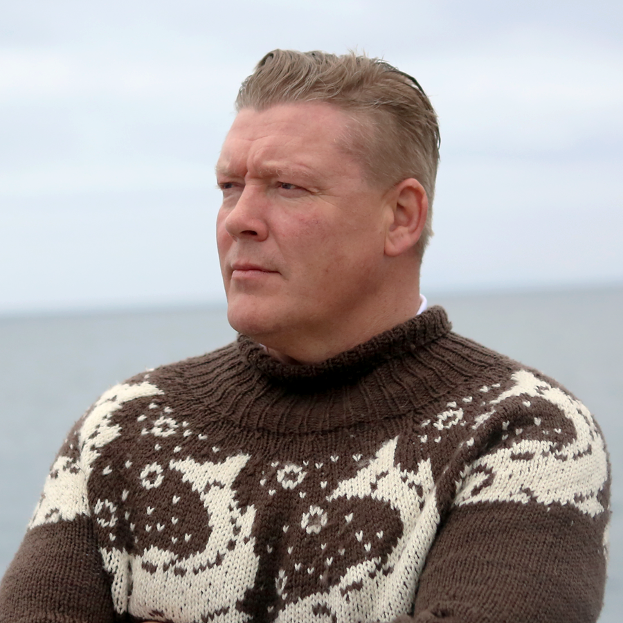 Gunnar, the founder and CEO, is looking away from the camera, dressed in a traditional islandic knit sweater.