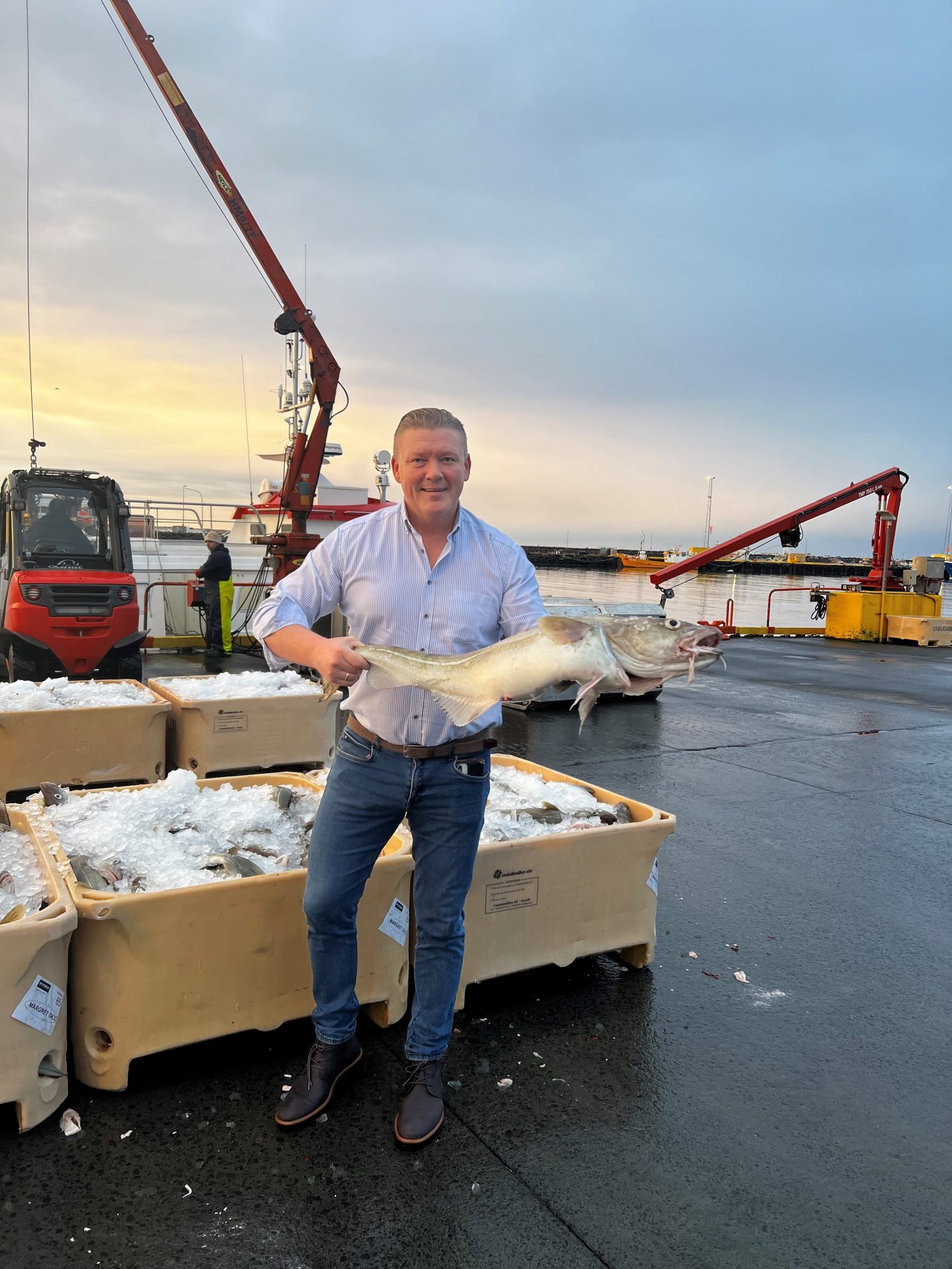 Gunnar Örlygsson, IceMar’s founder, is standing on a dock holding a big fish with both hands.